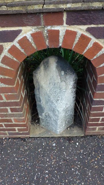 Old milestone set into brick wall outside Jack Stevens Close