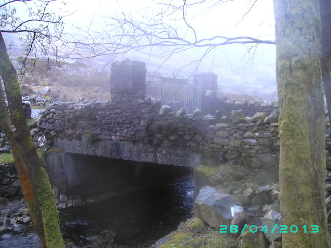 Footbridge over the river and the metal gates of the Cwm-Dyli Power Station